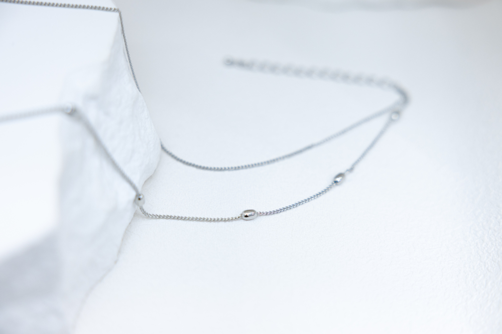 목걸이 橢圓珠墜鋯石蝴蝶結雙層喜平鍊 / 銀色